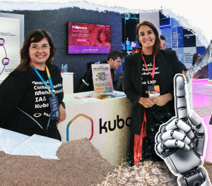 Duas participantes no estande do Kubo durante o CONCARH 2026, em frente ao balcão com a marca Kubo. A composição inclui uma ilustração de mão robótica, remetendo à inteligência artificial e tecnologia.